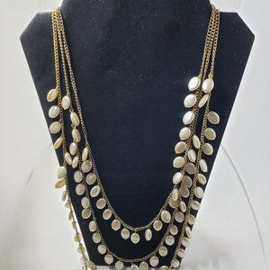 Vintage triple strand necklace. Gold tone with creamy beads.